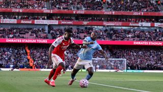 Bukayo Saka and Jeremy Doku contesting the ball during an Arsenal vs Man City game ahead of the 2026 Carabao Cup final