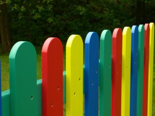 multicoloured garden fence in bright primary colours
