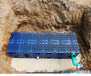 A plastic crate system in a pit dug into the ground to act as drainage