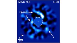 blue and white view of the star MWC 758 with its spiral arms