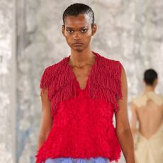A woman on the diotima spring/summer 2026 runway wearing an unexpected color combination.