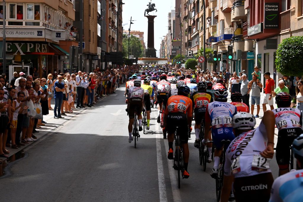 CABO DE GATA SPAIN AUGUST 31 A general view of the peloton competing while fans cheer during the 77th Tour of Spain 2022 Stage 11 a 1912km stage from ElPozo Alimentacin Alhama de Murcia to Cabo de Gata LaVuelta22 WorldTour on August 31 2022 in Cabo de Gata Spain Photo by Justin SetterfieldGetty Images