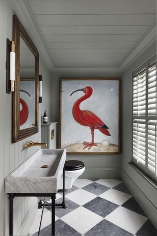 modern bathroom with pigeon colored walls, checkered marble floors, marble vanity and sink and large painting with flamingo