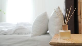 A reed diffuser in a bedroom