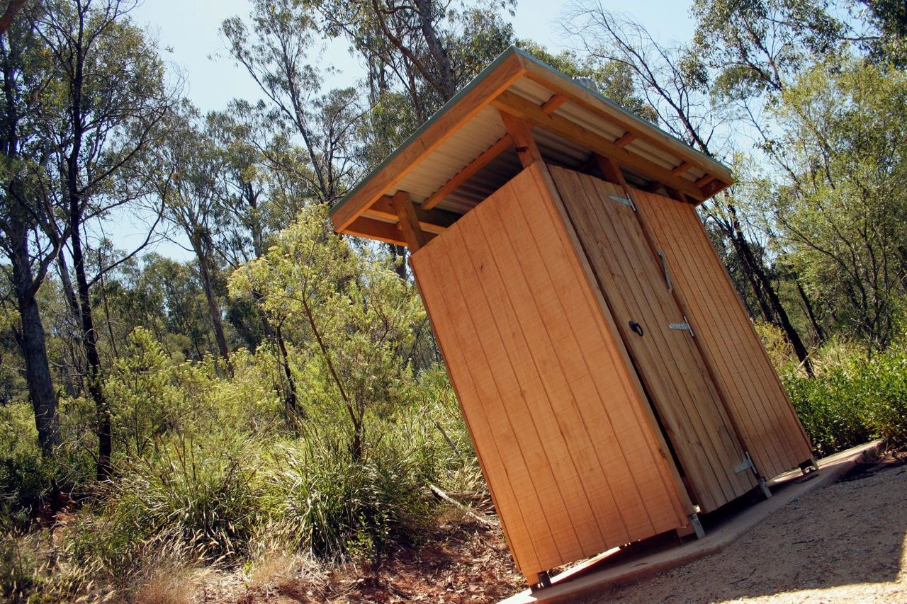 Wooden Out House In The Forest