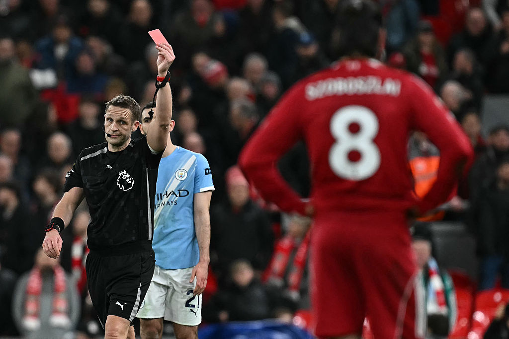 Criag Pawson gives a red card to Liverpool's Hungarian midfielder #08 Dominik Szoboszlai (R) at the end of the English Premier League football match between Liverpool and Manchester City at Anfield in Liverpool, north west England on February 8, 2026.