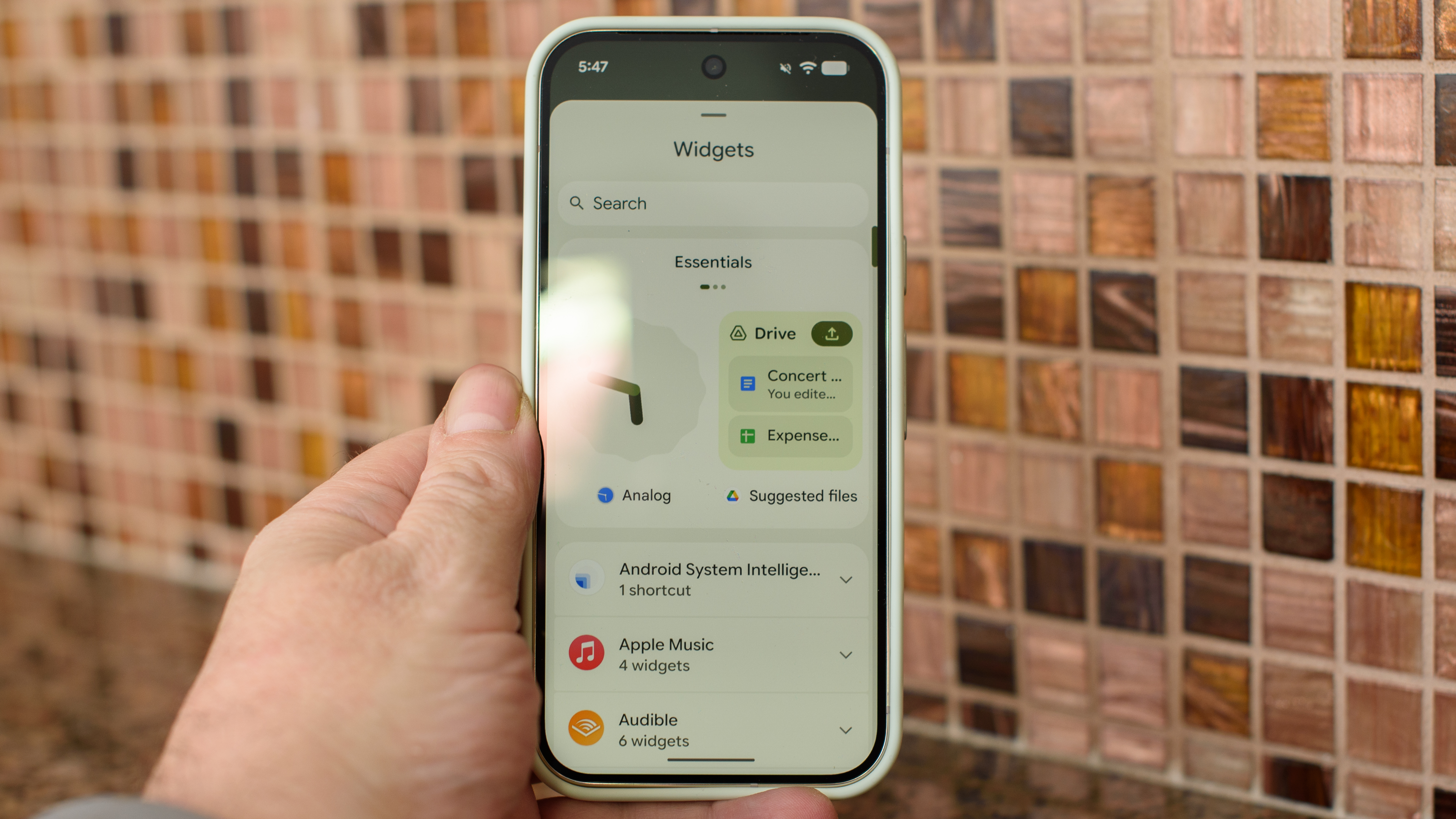 Google Pixel 10 Pro in Jade with checkered tile backsplash background