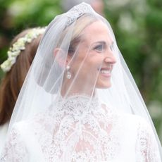 Harriet Sperling wears a diamond tiara at her wedding to Princess Anne's son, Peter Phillips, along with a cusom Emilia Wickstead lace wedding gown featuring a high neck and long sleeves