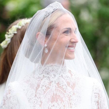 Harriet Sperling wears a diamond tiara at her wedding to Princess Anne's son, Peter Phillips, along with a cusom Emilia Wickstead lace wedding gown featuring a high neck and long sleeves