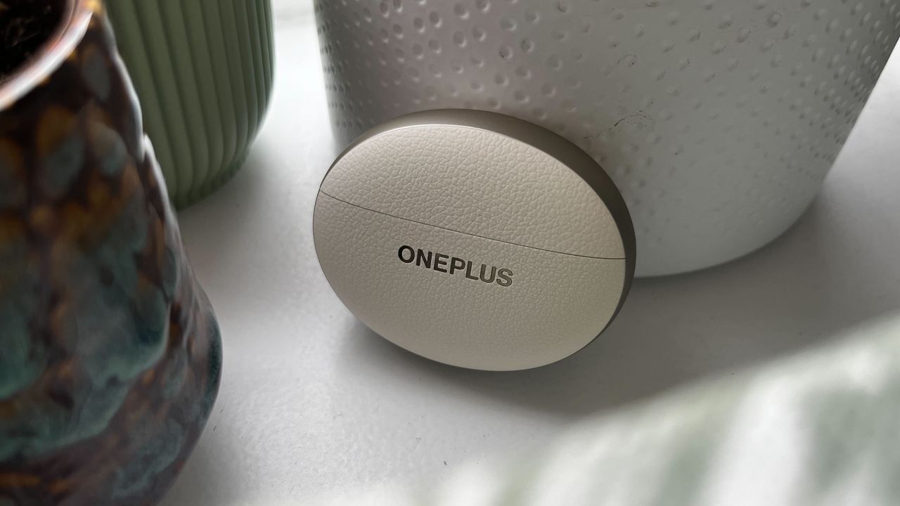 The OnePlus Buds Pro 3 on a shelf with some plants