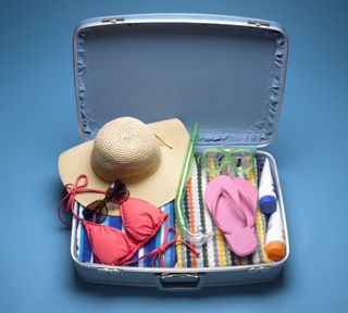 travel-sized sunscreen - Suitcase Packed with Beach Wear