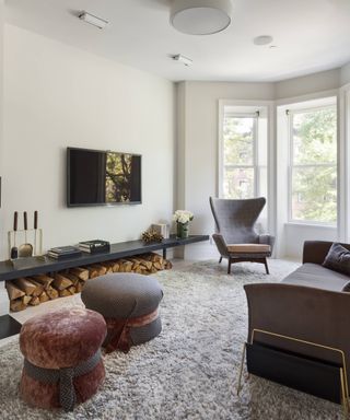 How to create a home theater in a beautiful autumnal living room scheme with a log fire, TV mounted onto the wall and comfy yet luxurious seating