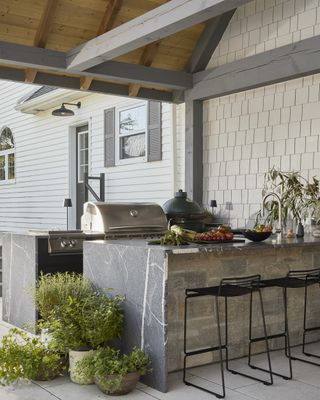 A backyard kitchen with granite countertops