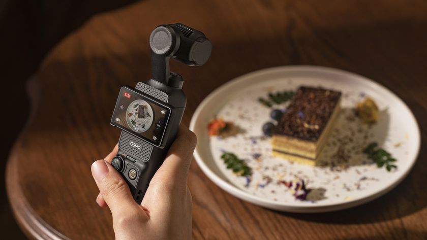 DJI Pocket 3 vlogging camera in the hand shooting video of fancy food on a table
