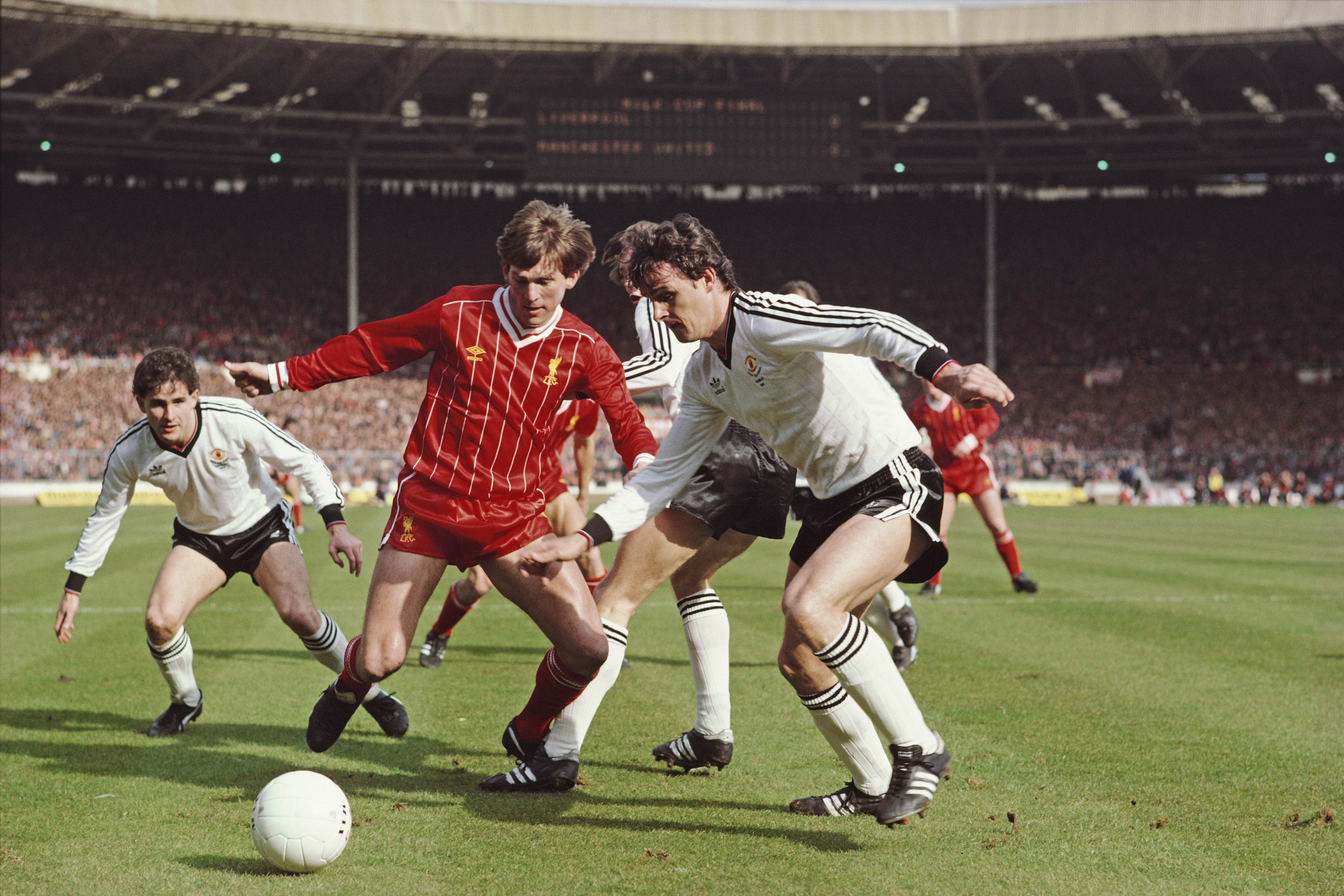 Liverpool's Kenny Dalgish and Manchester United's Kevin Moran compete for the ball in the 1983 League Cup final at Wembley.
