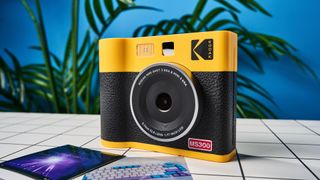 A black and yellow Kodak Mini Shot 3 Era 2-in-1 instant camera and printer