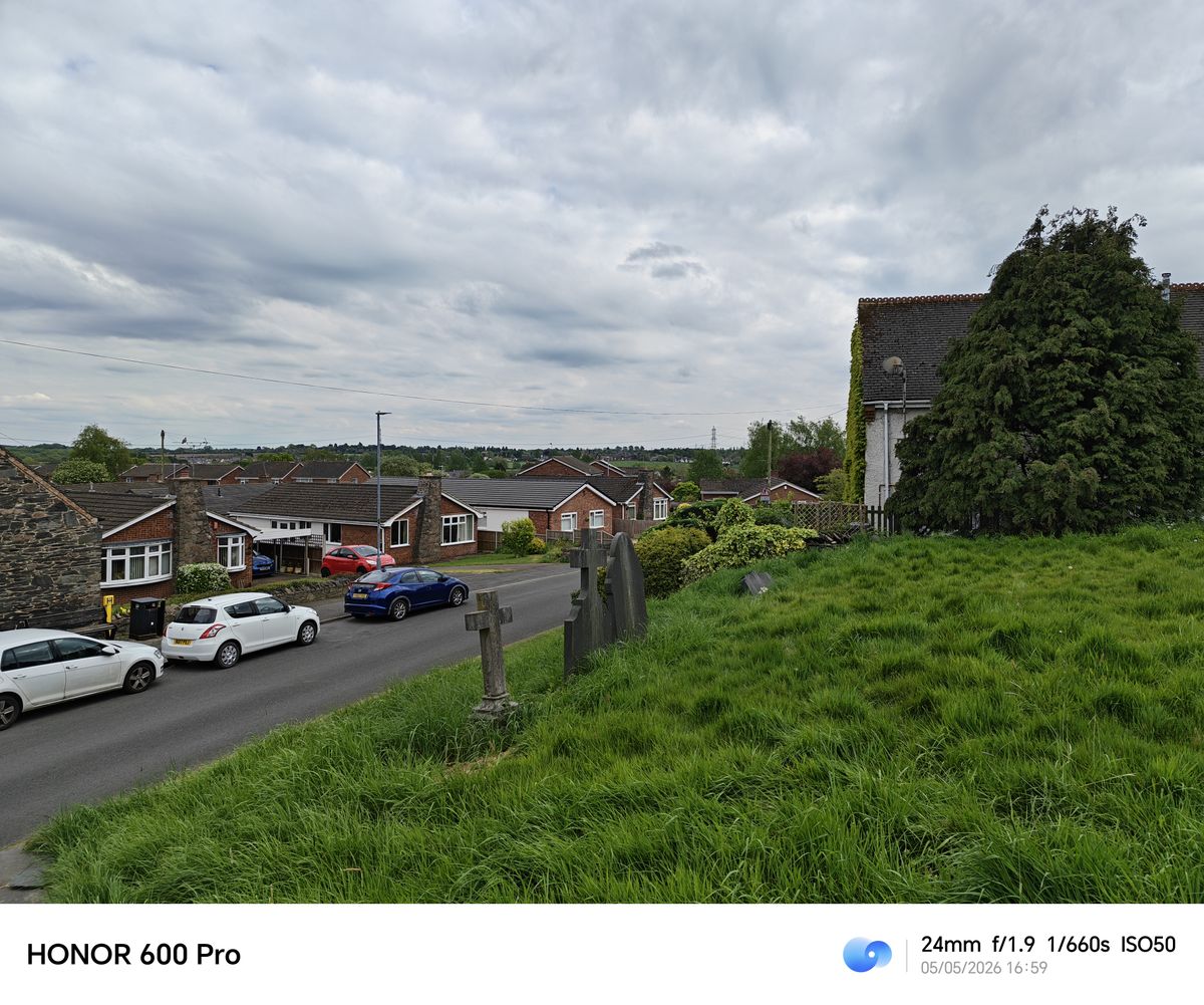 Village street, houses, and churchyard photographed with the Honor 600 Pro at 24mm