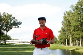 Bryson DeChambeau poses with the 2017 John Deere Classic trophy
