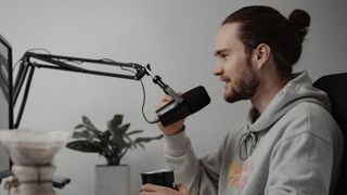 Man in studio talking into his Shure microphone