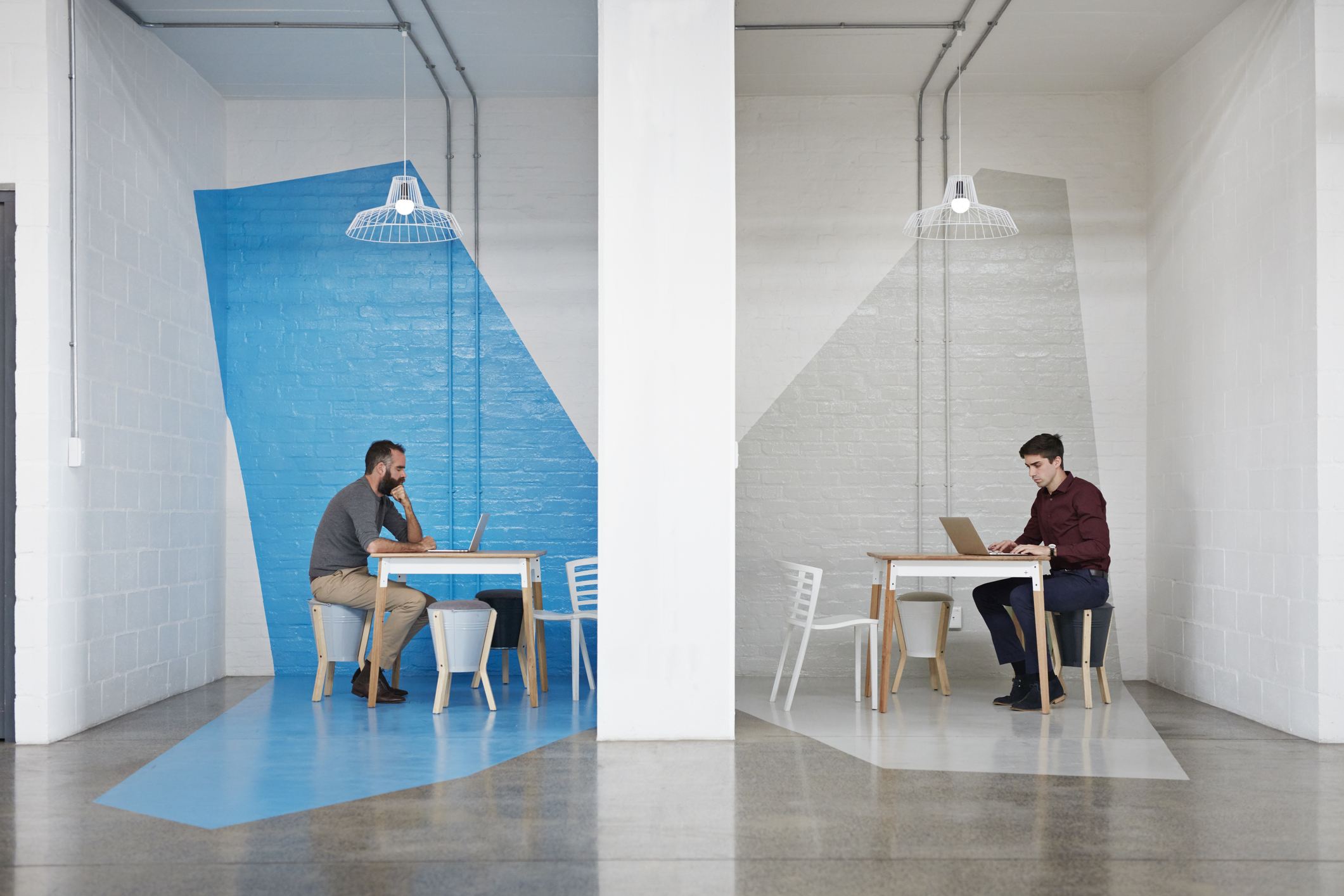 Two business men sitting in opposite booths