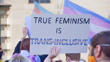 A protester holds a ‘True Feminism Is Trans-Inclusive’ placard during a trans rights demonstration outside Downing Street 