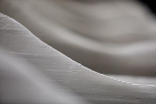 A detail shot showing the ridged surface of the 3D printed white ceramic