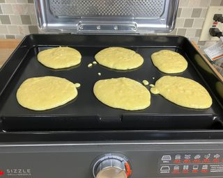 Wet cornmeal pancake batter on Ninja Sizzle Indoor Grill and Griddle appliance