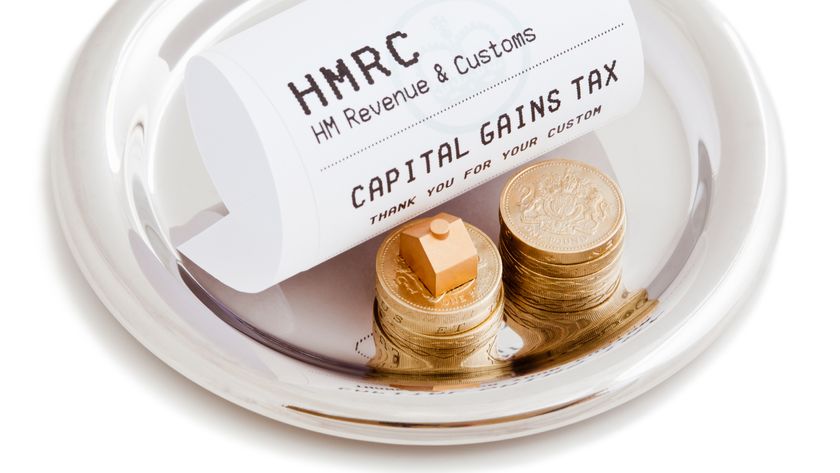 Waiter’s silver tray with till receipt from HMRC with capital gains tax written on, two piles of pound coins and a small model of a house on top of one pile of coins