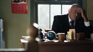Forest Whitaker as Bumpy Johnson sitting at a desk in Godfather of Harlem season 3