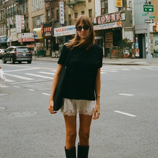 Lizzy Hadfield wearing lace shorts and tall boots