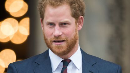 Prince Harry wearing a suit and military medals.