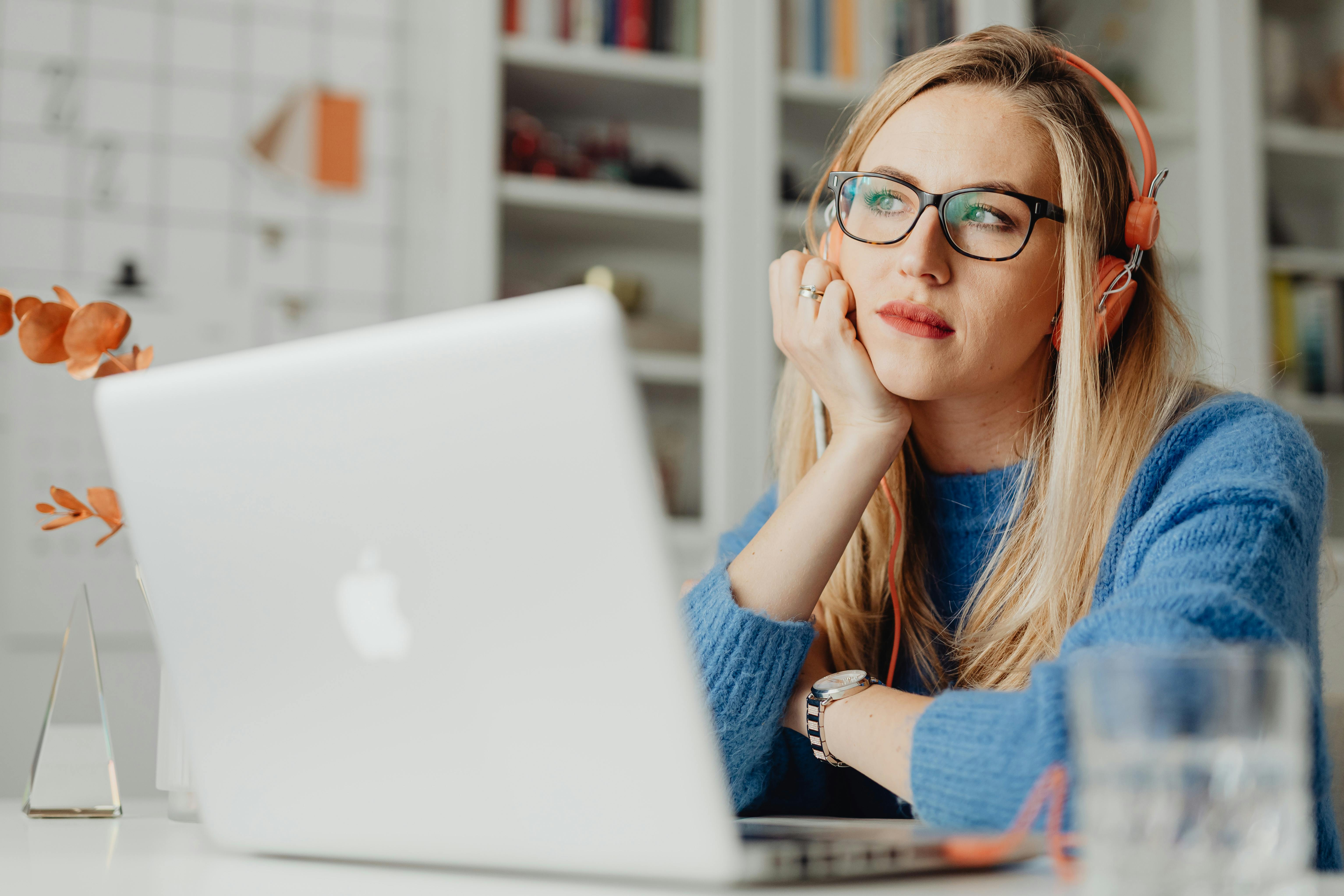 Woman sitting at laptop perplexed