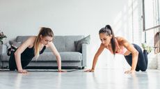 Two woman completing modified push ups together