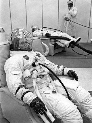 Apollo 7 command module pilot Donn Eisele is seen reclining on Oct. 11, 1968, hours before his launch into Earth orbit for 11 days. Eisele can be seen wearing two Omega Speedmaster Professional chronographs: his NASA-issued watch on his right arm (with white Velcro strap) and his personal watch on his left arm (with black Velcro strap).