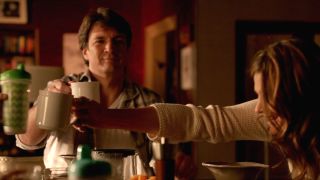 Nathan Fillion toasts his coffee mug with Stana Katic and kids in Castle.