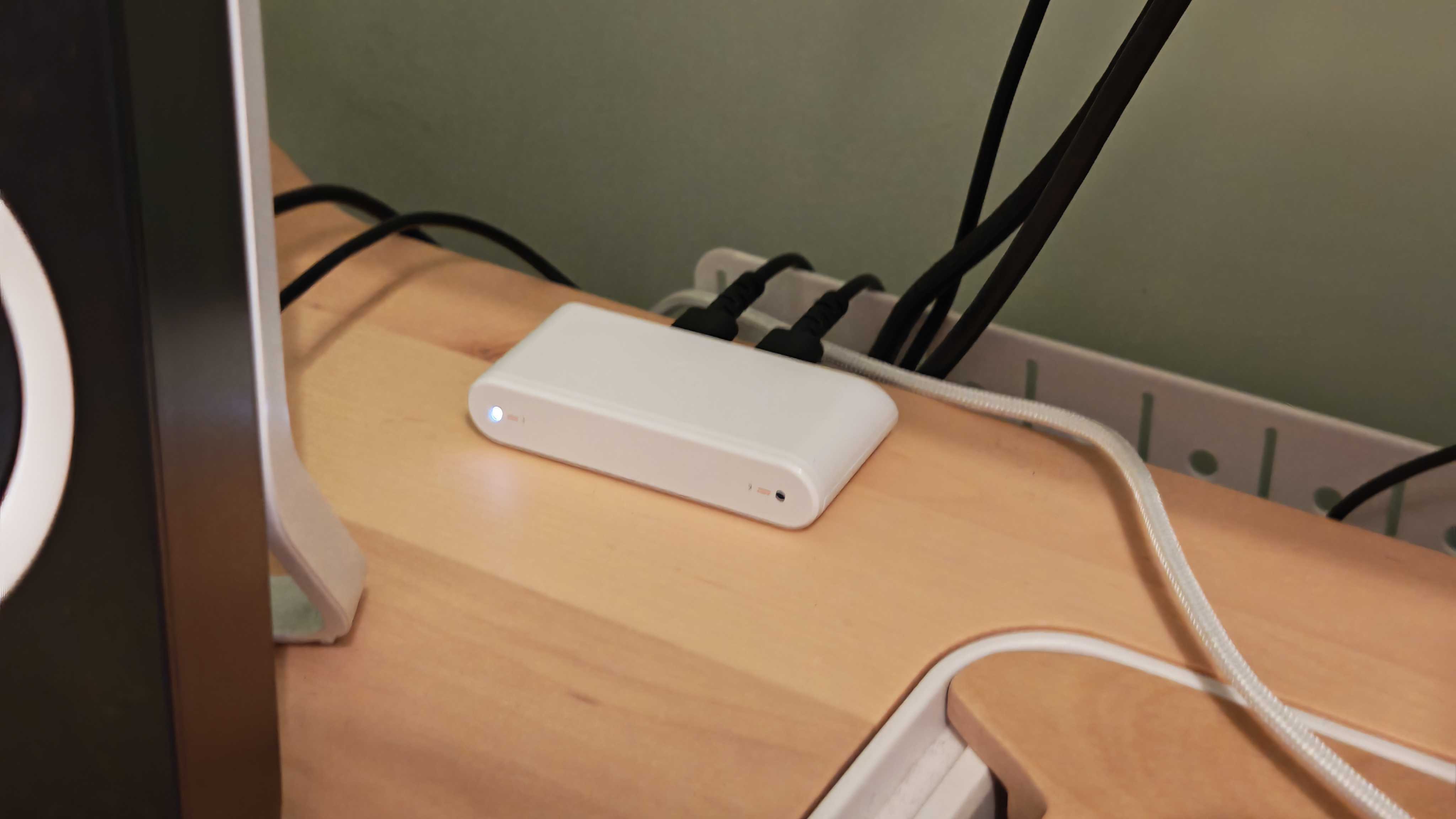 The Astro A20 X gaming headset on a wooden desktop surface.