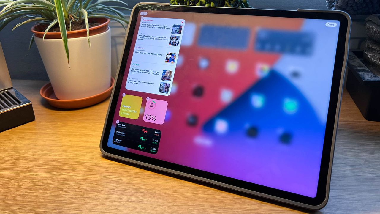 A photograph of the 12.9in Apple iPad Pro on table with some plants