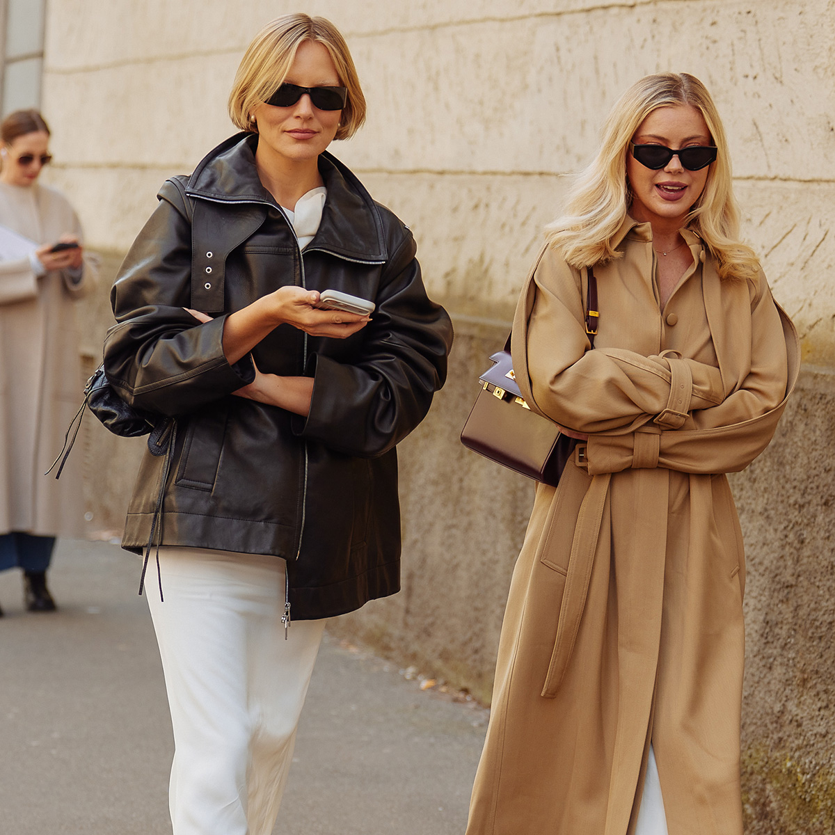 Two women walk in paris during fashion week.