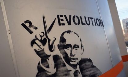 Graffiti in Yekaterinburg, Russia: Despite hundreds of thousands of Russians protesting Putin's return, the Prime Minister is expected to win the presidency Sunday.