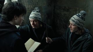 Fred and George showing Harry the Marauder's Map. the