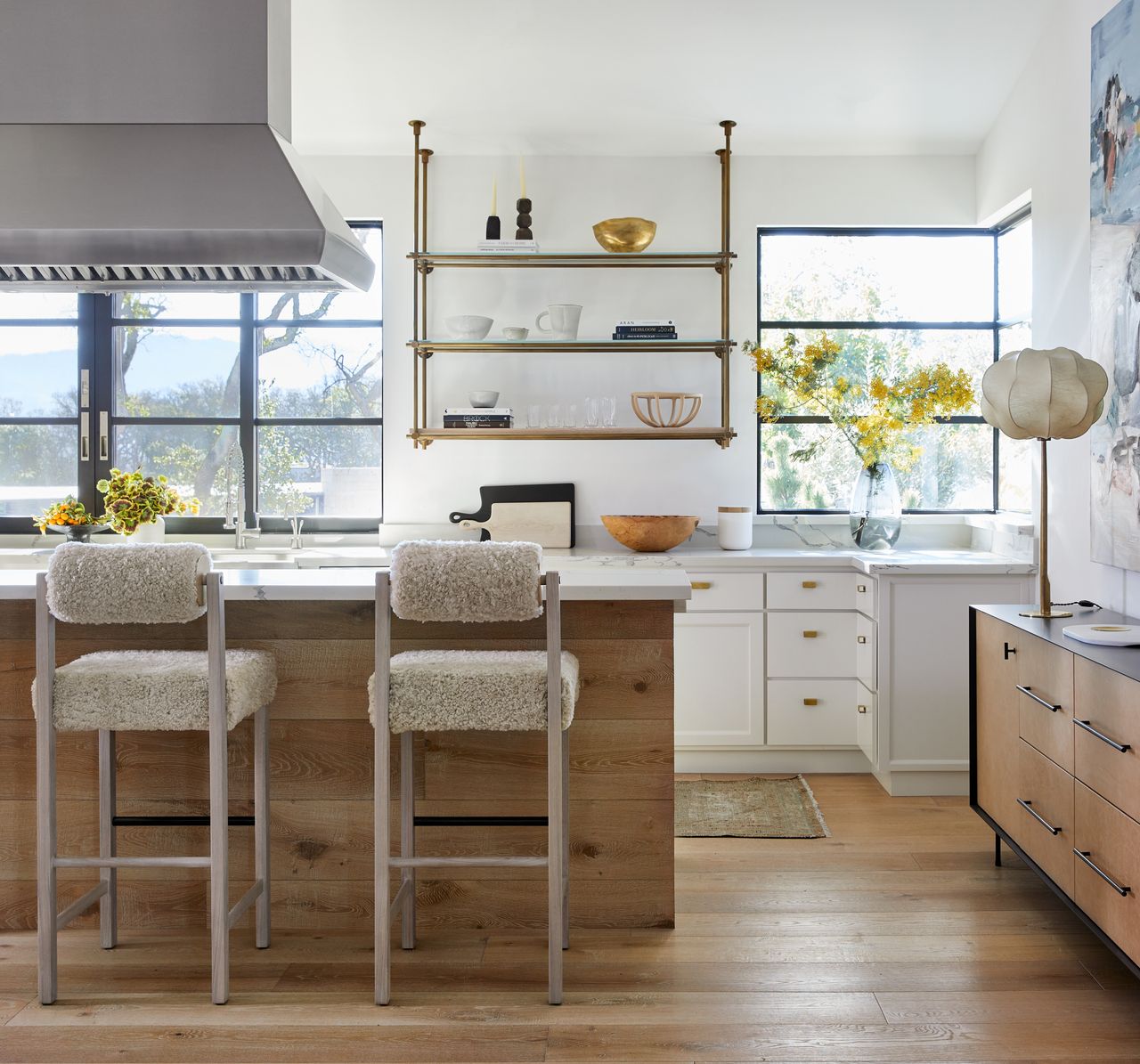 A kitchen with a range hood above island