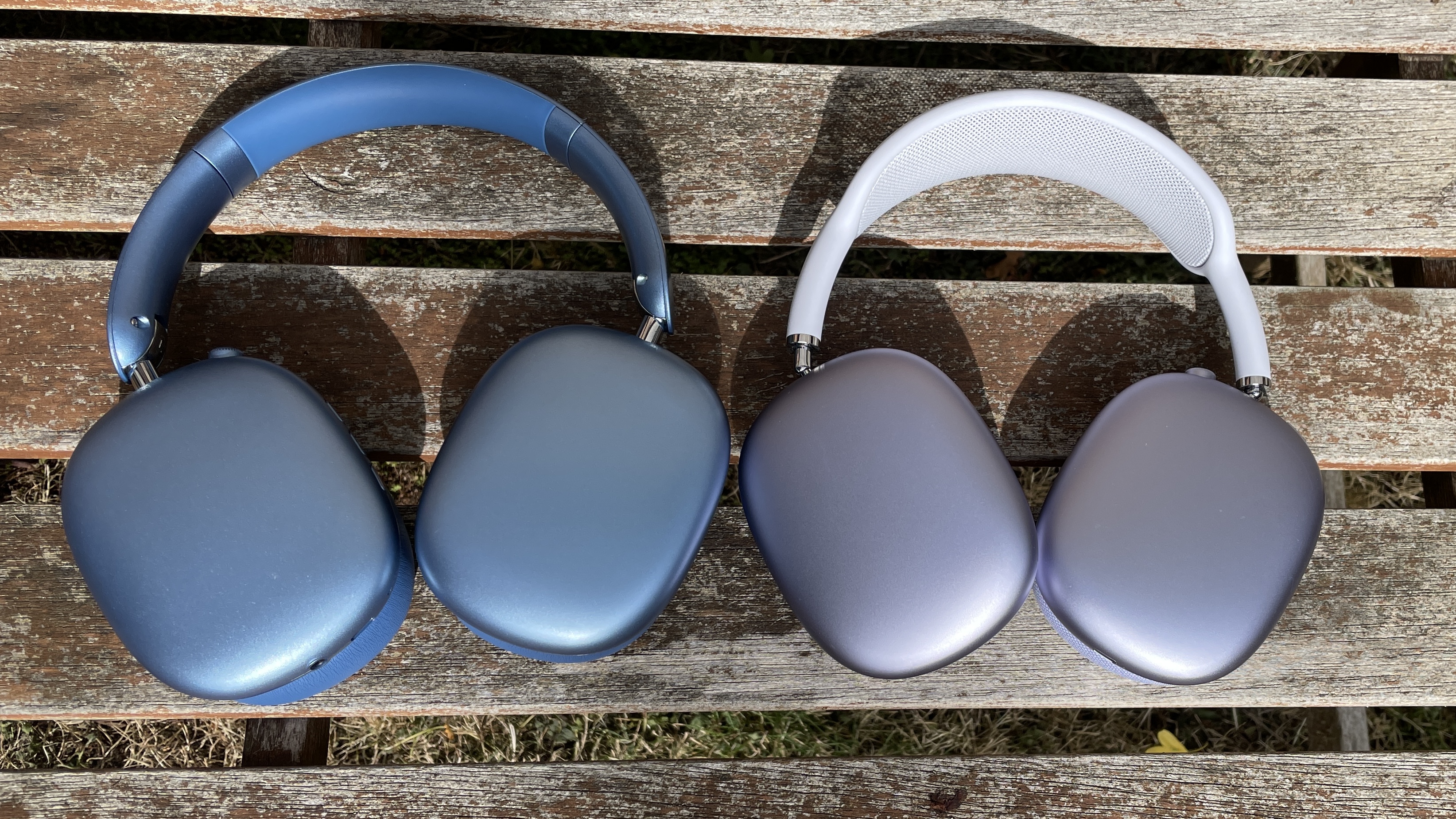 Wentronic YO1 (AirPods Max dupe) headphones in blue with AirPods Max nearby to compare and contrast their looks, outside on a sunny day