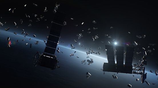 A rendering in low orbit above Earth, showing many pieces of space debris of various sizes floating about.