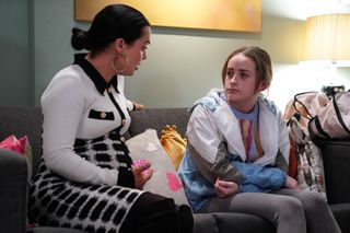 Whitney Dean sits with Britney in her living room in EastEnders 