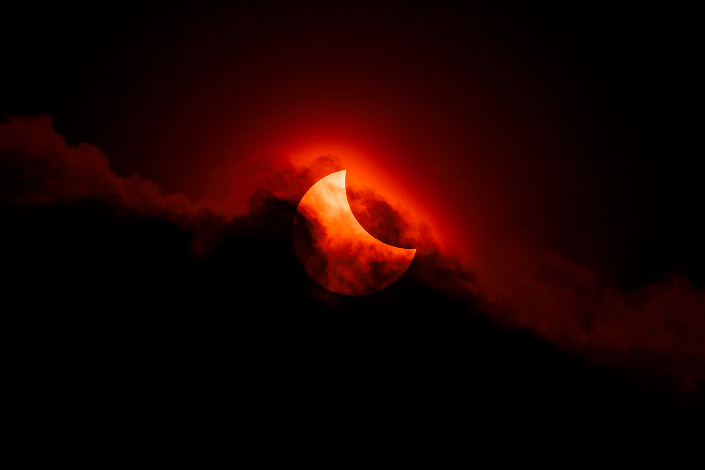 Partial solar ecplipse on cloudy day.