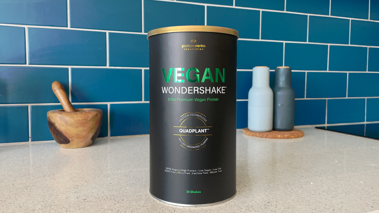 A tub of Protein Works Vegan Wondershake on a kitchen worktop