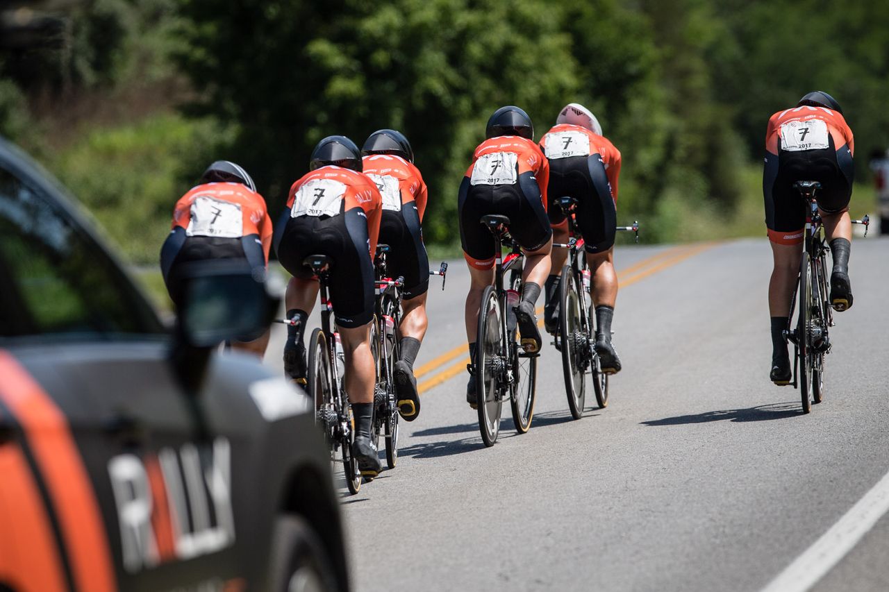 The Rally women stay in tight formation over the top of the climb