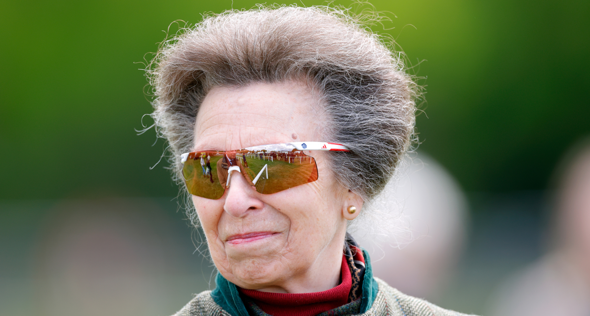 Princess Anne wearing sunglasses and smirking