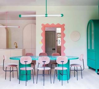 A pink and mint green dining room