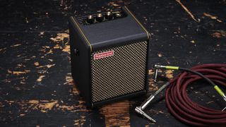 Positive Grid Spark Mini on a stage with guitar cables 